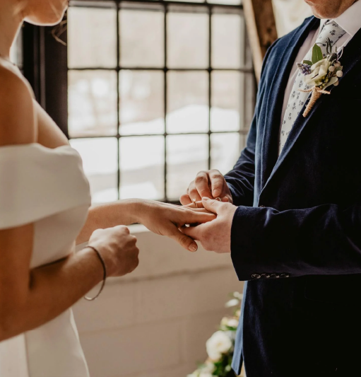 mari et femme en train de se passer la bague au doigt